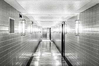 Symmetrical black and white tiled hallway with elevator