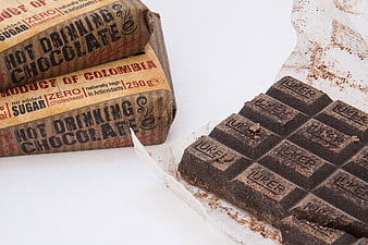 Dark chocolate bar and hot drinking chocolate packaging on white