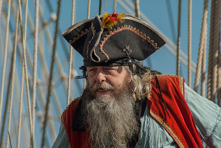 Bearded Pirate Costume Portrait On Sailboat Rigging