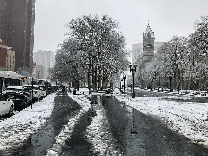 Snowy City Street in Brooklyn with Park and Architecture