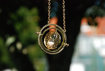 Golden hourglass pendant necklace with rotating rings