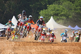 Motocross riders racing on dirt track