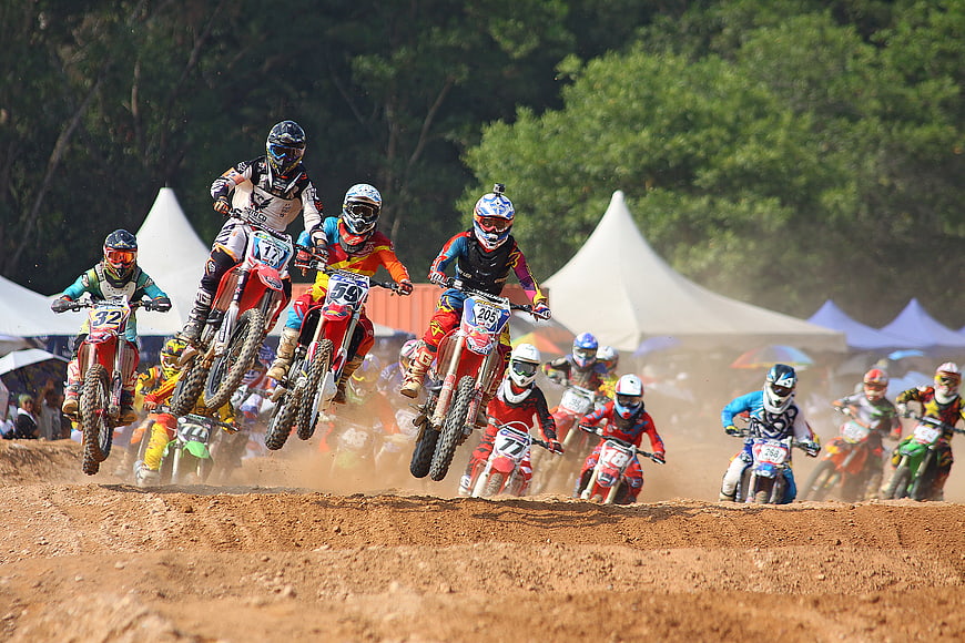 Motocross riders racing on dirt track