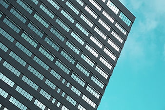 Modern Office Building Facade with Blue Sky Background