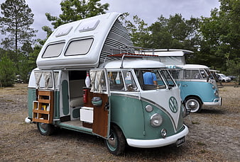 Vintage VW Camper Van with Pop-Top Roof at Campsite