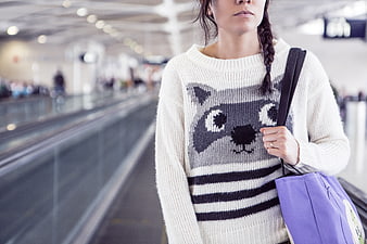 Woman in Raccoon Sweater at Airport