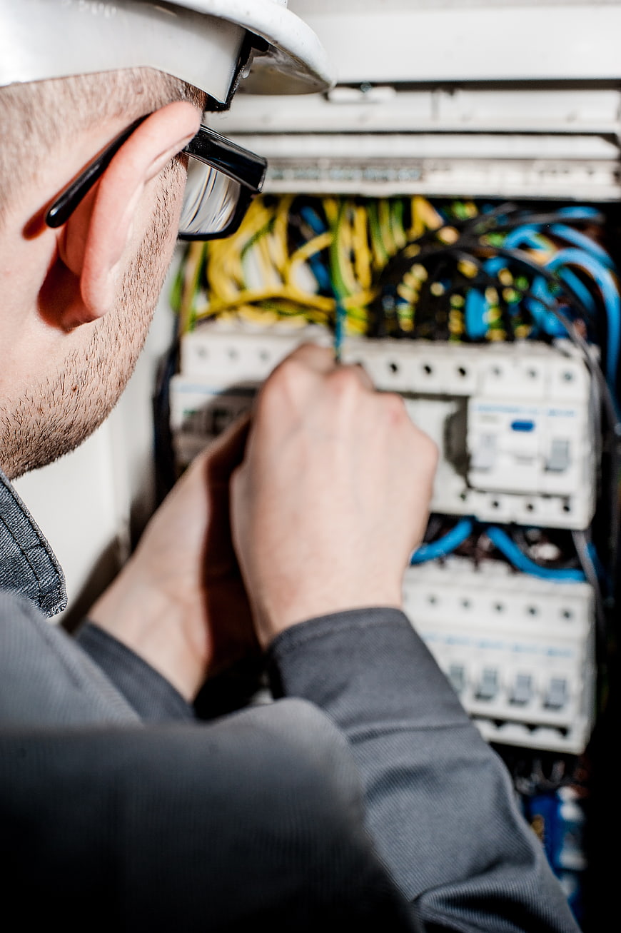 Electrician Repairing Electrical Panel with Wires