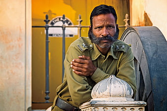 Portrait of Indian Security Guard in Olive Uniform