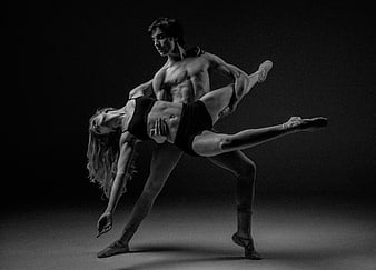Black and white contemporary ballet dancers in dramatic lift pose