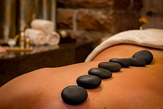Hot stone massage on a woman's back in a luxury spa