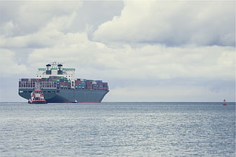 Large Container Cargo Ship at Sea with Tugboat