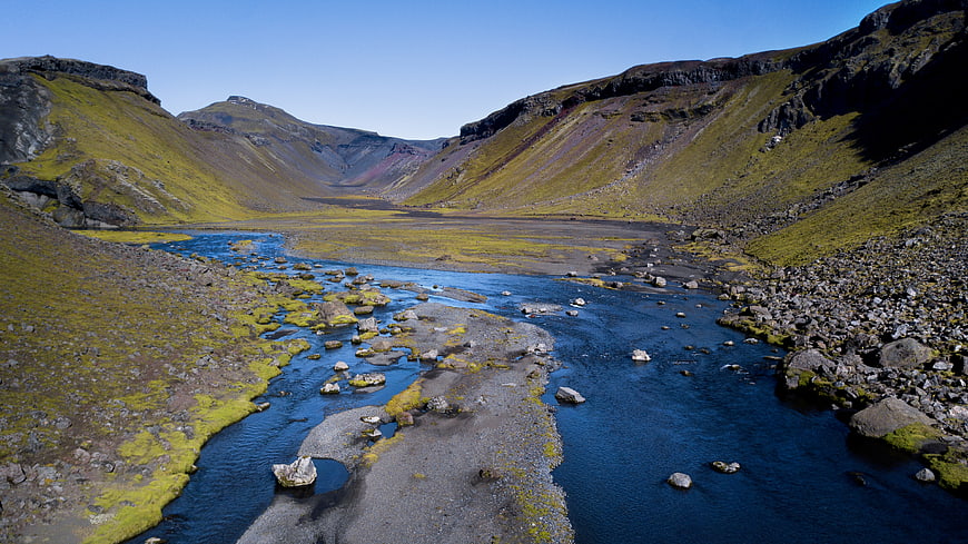 Scenic Icelandic River Valley with Mossy Mountains
