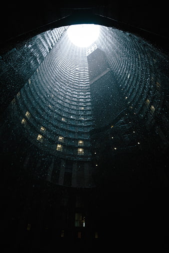 Low angle view of curved skyscraper in rain