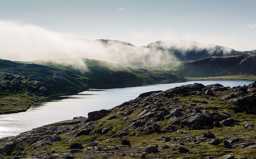 Misty Mountain Lake Landscape with Rocky Foreground