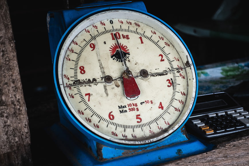 Vintage blue mechanical weighing scale with calculator