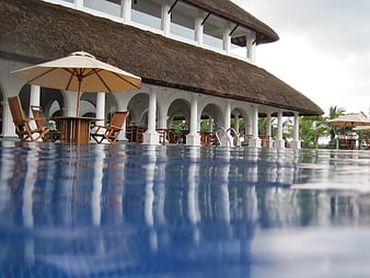 Tropical Resort Pool with Thatched Roof Pavilion