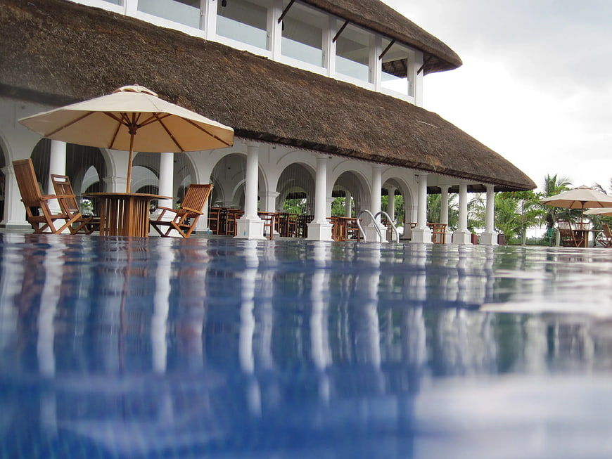 Tropical Resort Pool with Thatched Roof Pavilion