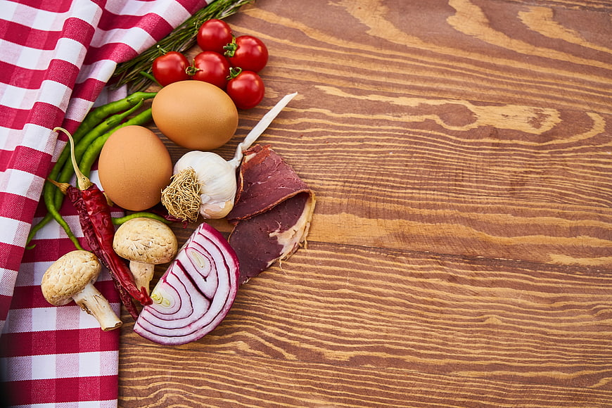Fresh cooking ingredients on wooden table with copy space