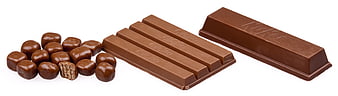 KitKat chocolate bars and caramel candies on white background
