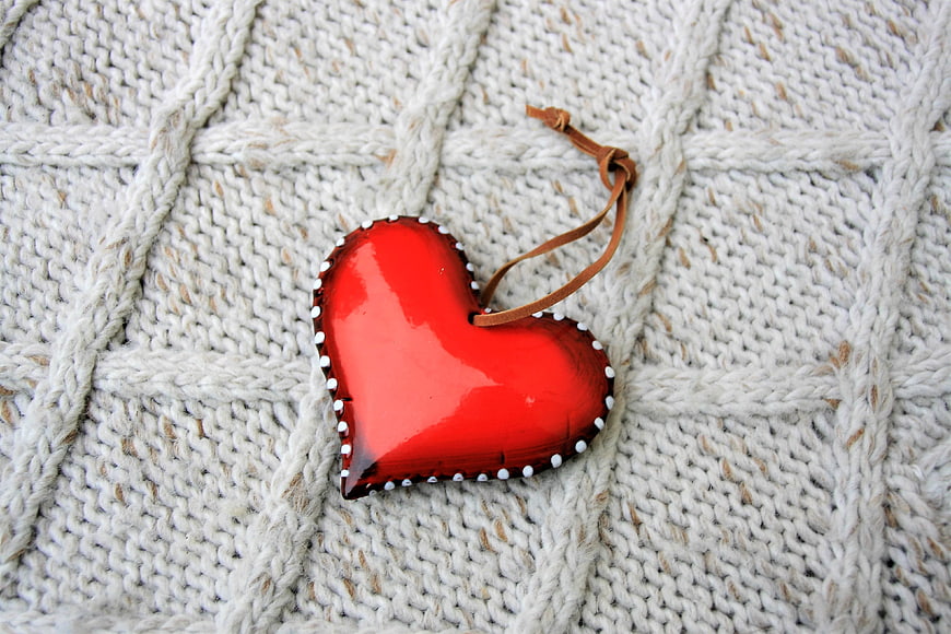 Red Heart Ornament on Textured White Knitted Fabric