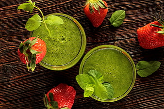 Green Smoothie Bowls With Fresh Strawberries And Mint On Rustic Wood