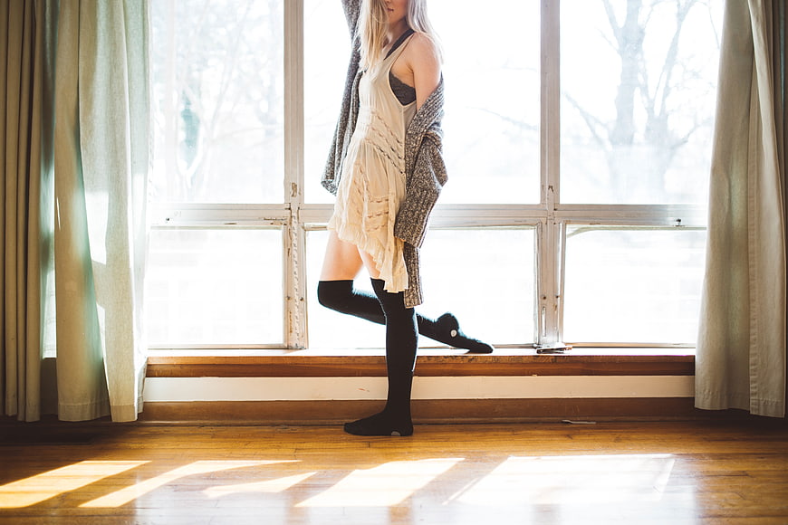 Woman in White Dress and Knee-High Socks by Window