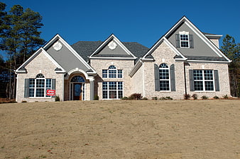New Brick Home Exterior With Open House Sign