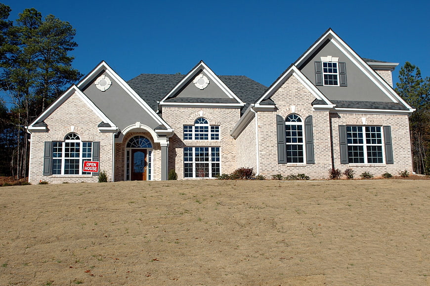 New Brick Home Exterior With Open House Sign