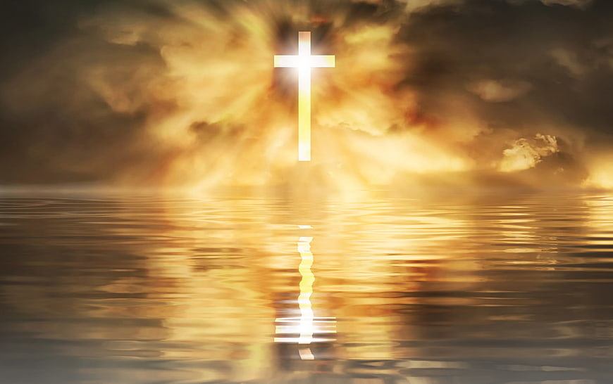 Glowing Christian Cross Reflected in Golden Lake at Sunset