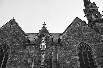 Black and white gothic church facade with statue