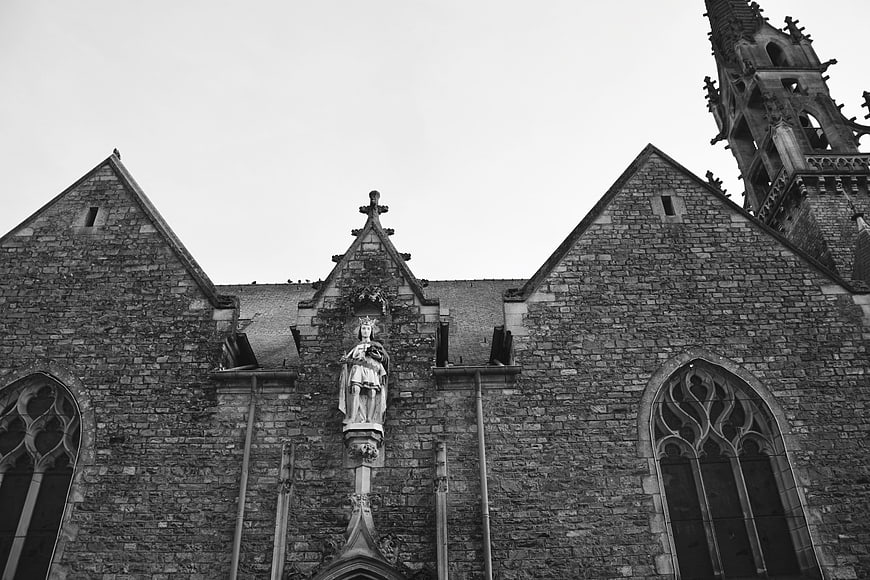 Black and white gothic church facade with statue