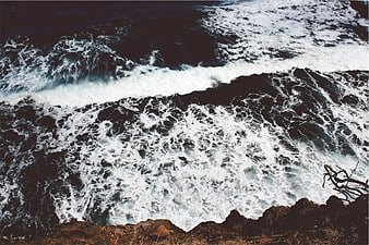 Aerial View of Crashing Ocean Waves on Rocky Coastline