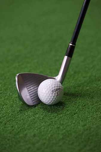 Golf club and ball on artificial turf