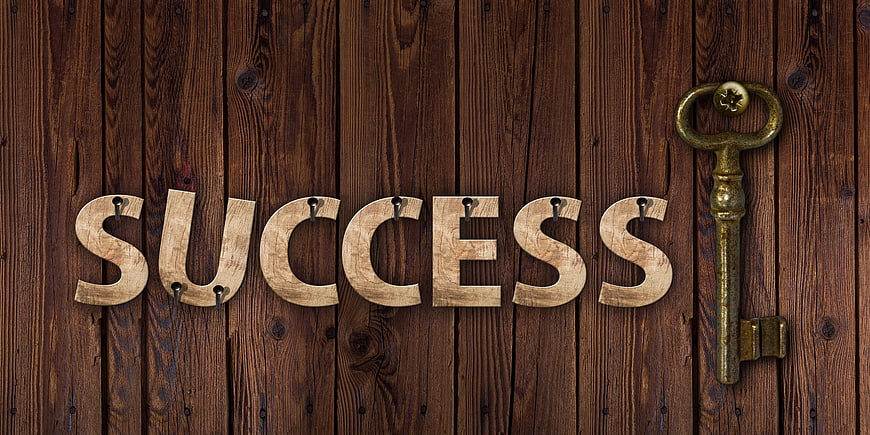 Wooden Success Letters And Vintage Key On Dark Wood Background