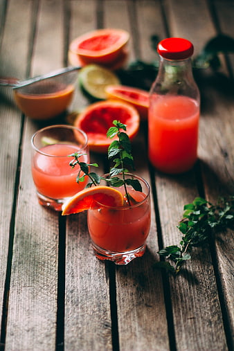 Fresh Grapefruit Juice with Mint on Rustic Wood