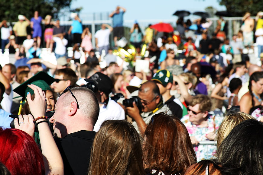 Crowded Outdoor Event with Spectators and Photographers