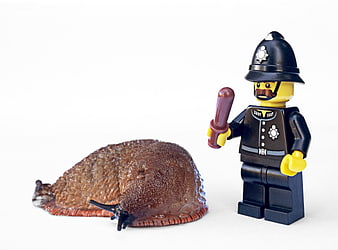 Lego British Police Officer Standing Next To Large Slug On White Background