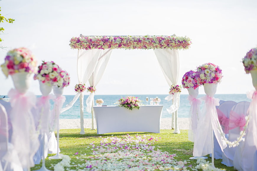 Beach Wedding Ceremony Setup with Floral Arch and Ocean View