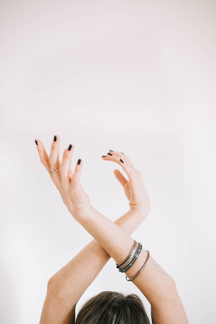 Woman's Hands with Black Nails and Silver Bracelets