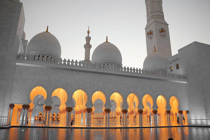 Grand Mosque Architecture with Golden Arches and Reflections