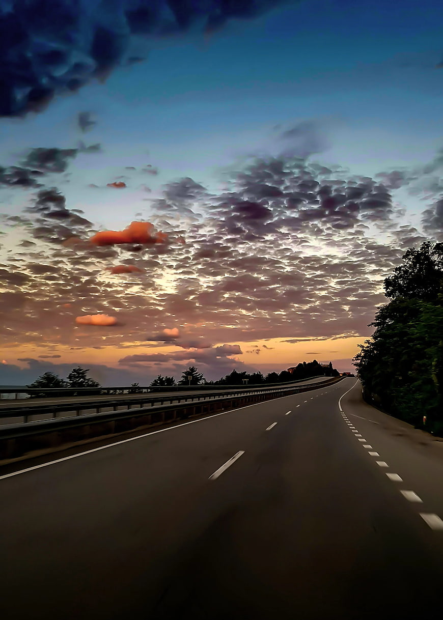 Empty Highway at Sunset with Dramatic Clouds