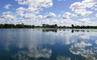 Serene Lake with Cloud Reflections and Blue Sky
