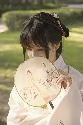 Young Asian Woman in Traditional Hanfu Holding Painted Round Fan
