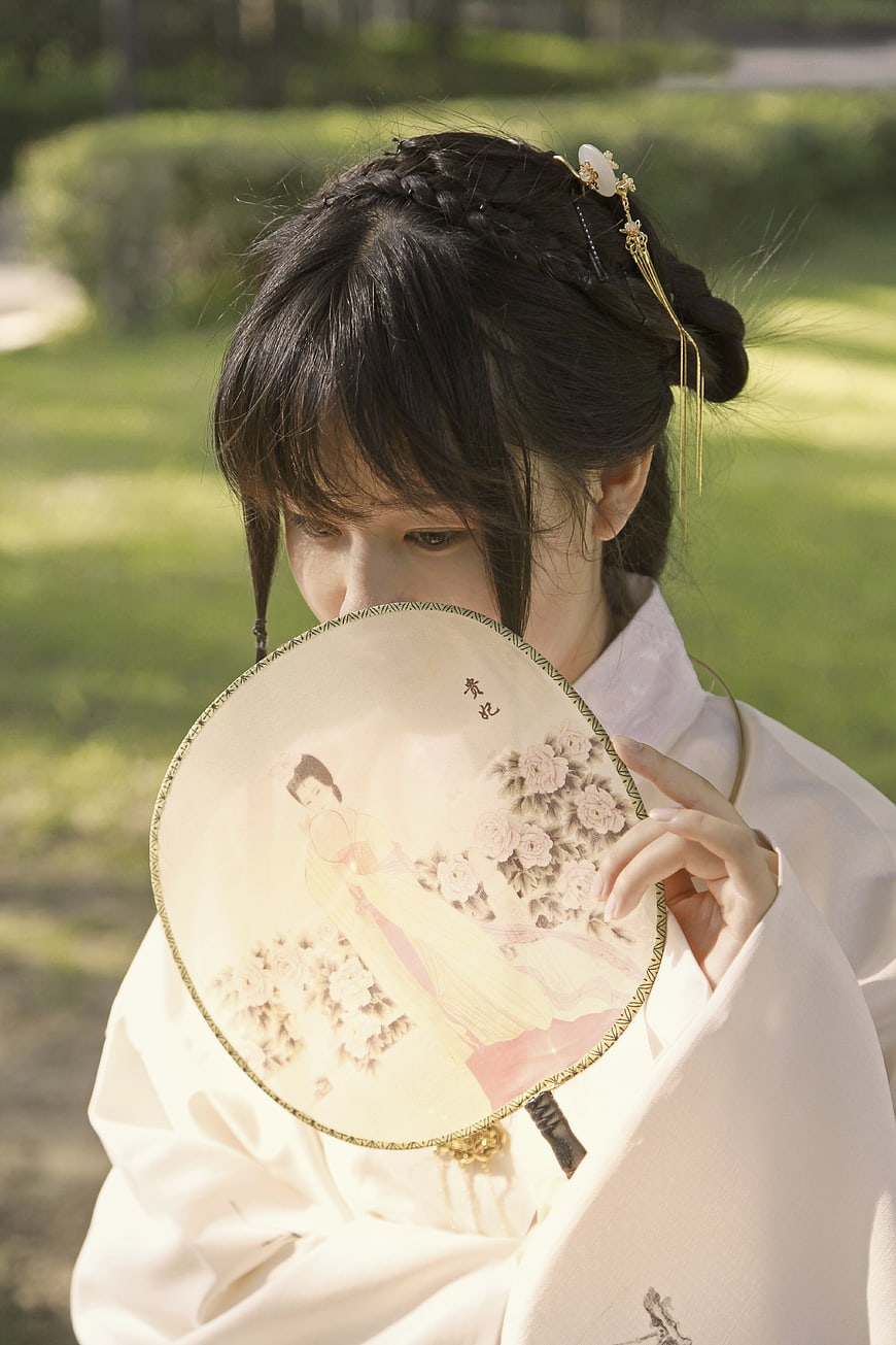 Young Asian Woman in Traditional Hanfu Holding Painted Round Fan