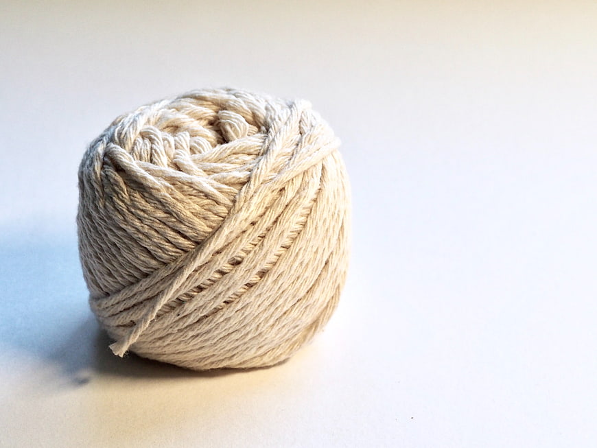 Ball of natural jute twine on white background