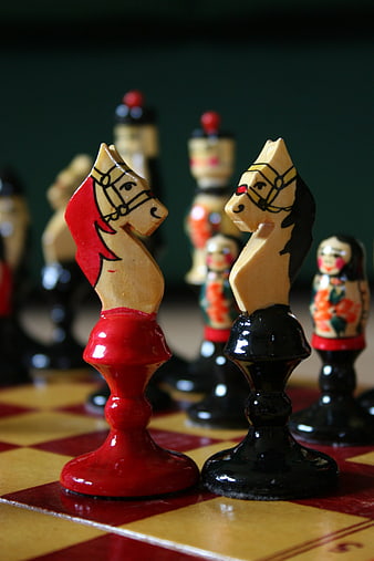Hand-Painted Wooden Chess Knights on Checkered Board