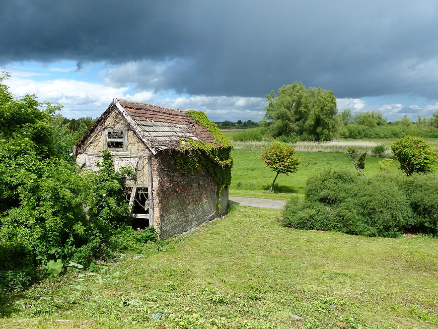 Abandoned rustic barn in rural landscape under stormy sky