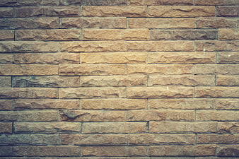 Textured beige stone brick wall background pattern