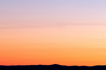 Gradient Sunset Sky Over Silhouette Hills
