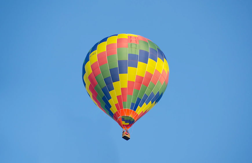Colorful Hot Air Balloon Flying in Blue Sky